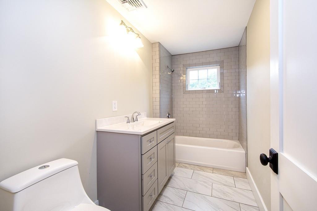 128 Washington Street, Unit R Hanover, MA 02339 - Photo 21 of 29 a bathroom with a sink a toilet and shower