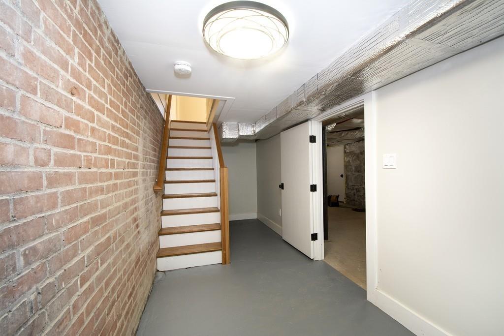 128 Washington Street, Unit R Hanover, MA 02339 - Photo 26 of 29 a view of a hallway with stairs and wooden floor