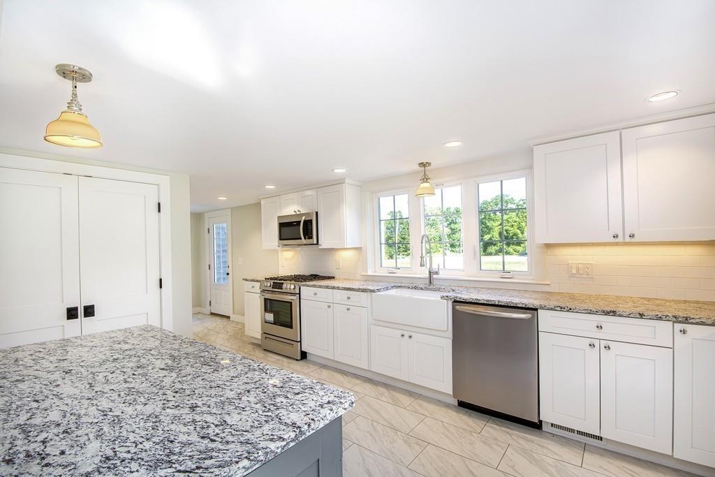 128 Washington Street, Unit R Hanover, MA 02339 - Photo 7 of 29 a large kitchen with cabinets appliances and a window
