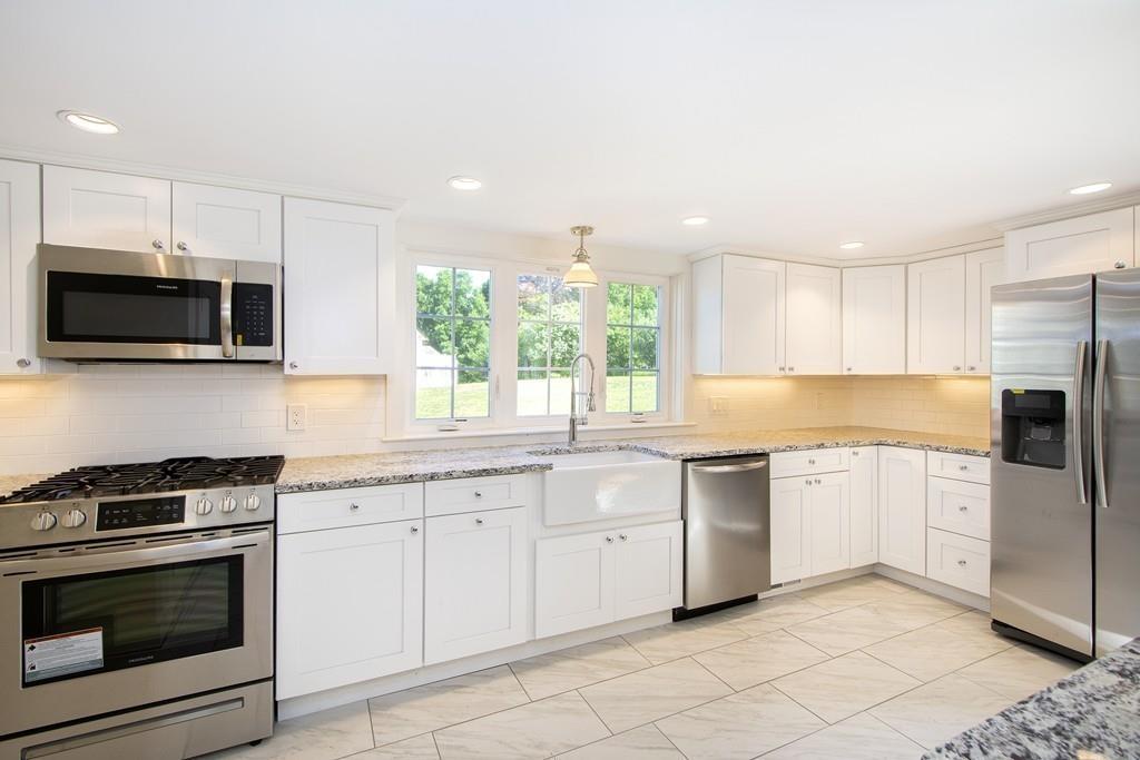 128 Washington Street, Unit R Hanover, MA 02339 - Photo 8 of 29 a kitchen with granite countertop white cabinets stainless steel appliances and a sink