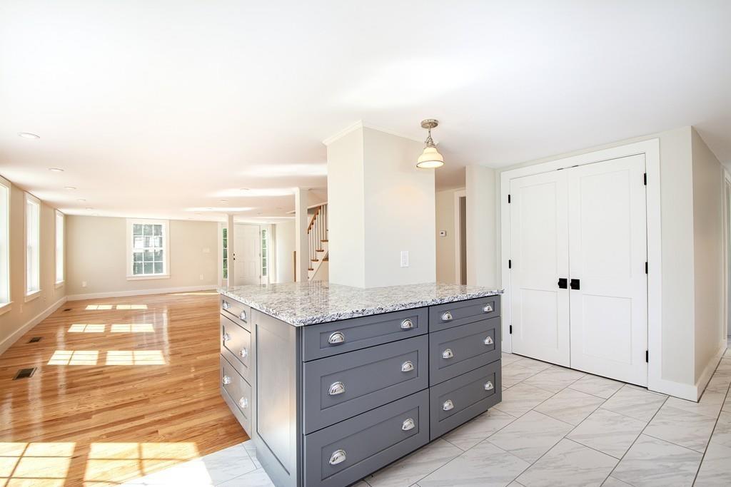 128 Washington Street, Unit R Hanover, MA 02339 - Photo 10 of 29 a spacious bathroom with a granite countertop sink a mirror and a shower