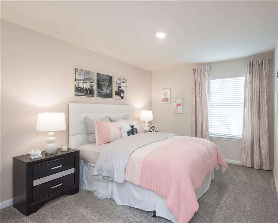 2246 Ashton Drive Conyers, GA 30013 - Photo 14 of 18 a bedroom with a bed and a night stand