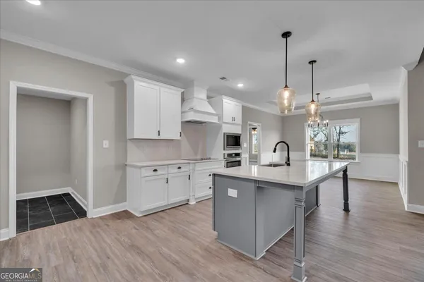 a large kitchen with stainless steel appliances kitchen island a large island in the center