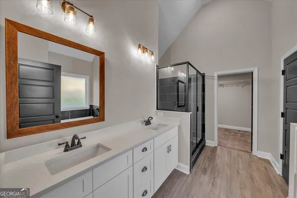 a view of a kitchen with wooden floor and a refrigerator