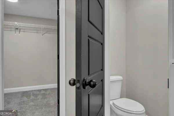 an empty room with a window and ceiling fan