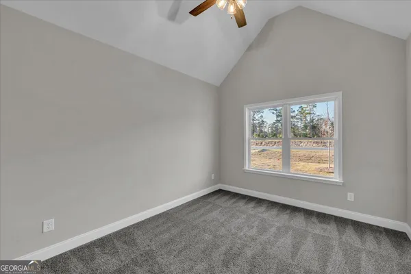 a bathroom with a granite countertop toilet sink and mirror
