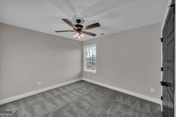 a view of a livingroom with a ceiling fan and a chandelier fan