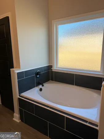 a view of an empty room with a fireplace and a window