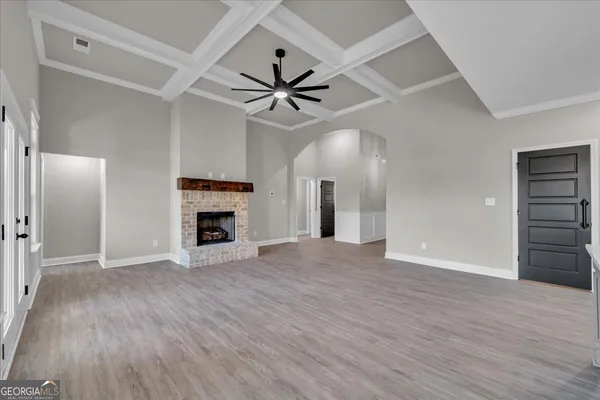 a view of an empty room with a fireplace and a window