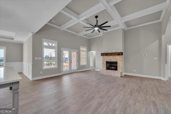 a large white kitchen with cabinets a sink and appliances