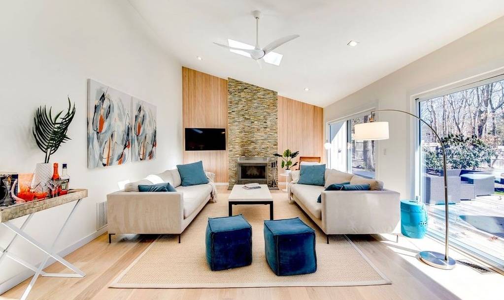 a living room with fireplace furniture and a flat screen tv