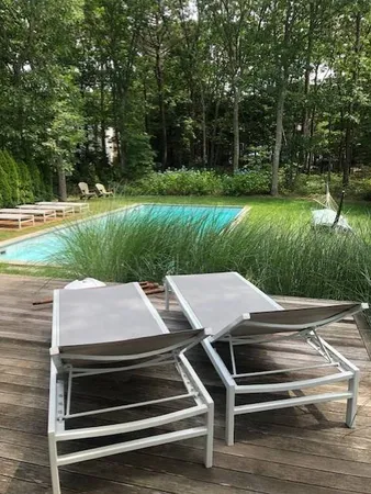 a wooden bench sitting next to a yard