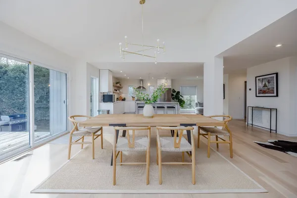a dining room with furniture and a floor to ceiling window