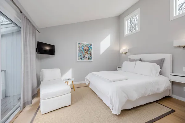 a bedroom with a bed and a chair