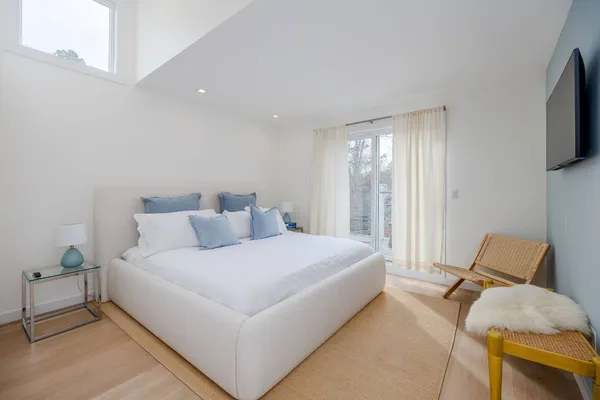 a bedroom with a bed and flat screen tv