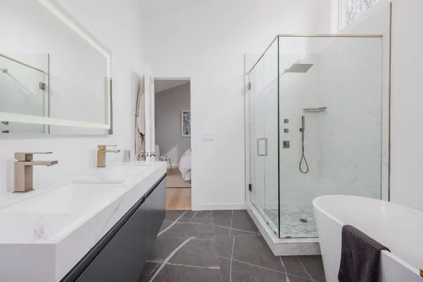 a bathroom with a granite countertop sink a toilet and shower