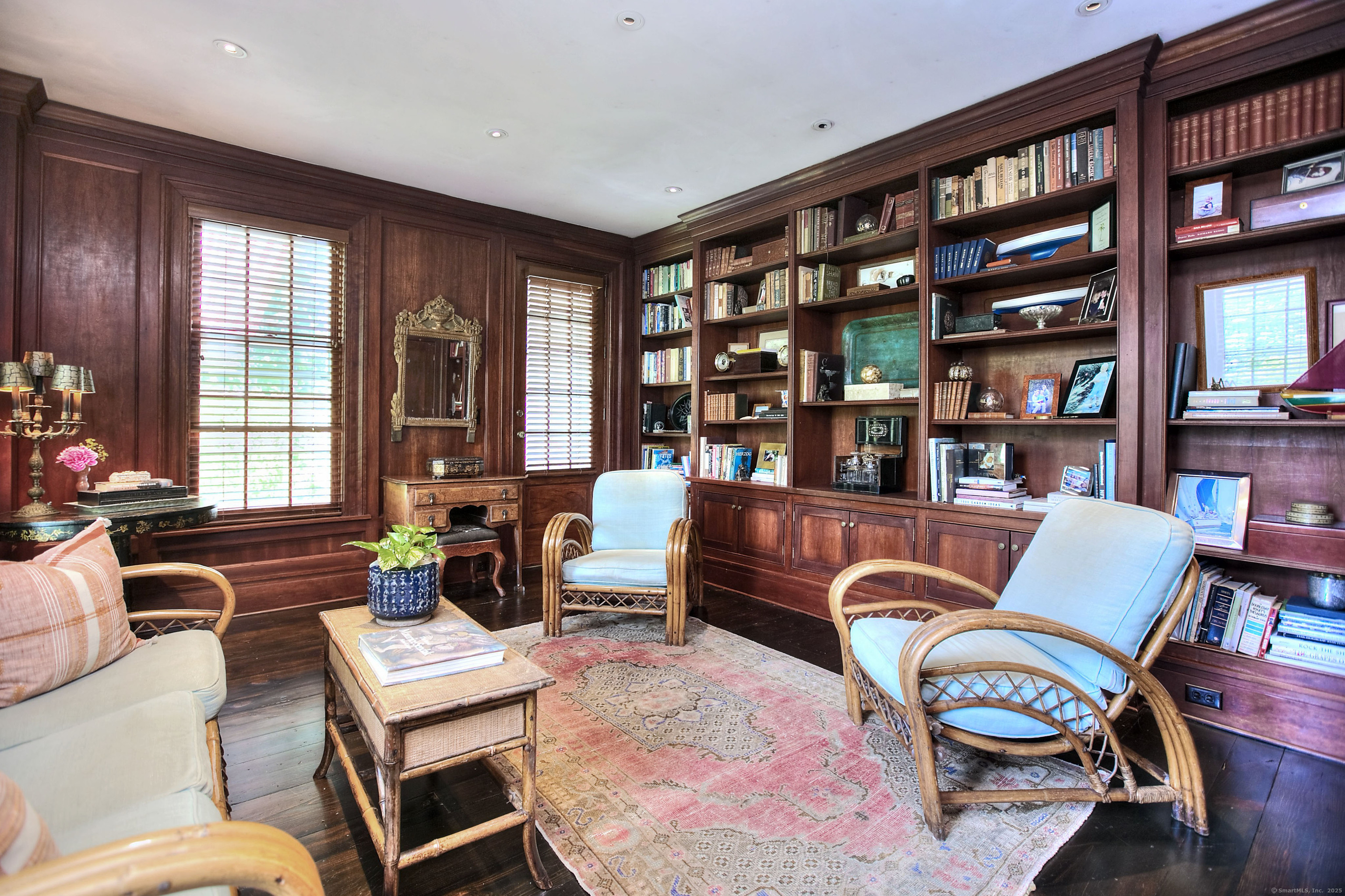 2683 Bronson Road Fairfield, CT 06824 - Photo 11 of 39 a living room with furniture a bookshelf and a large window