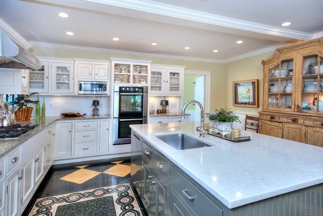 a kitchen with stainless steel appliances granite countertop a sink and cabinets