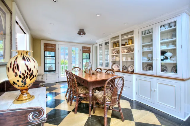 a dining room with furniture a window and a chandelier
