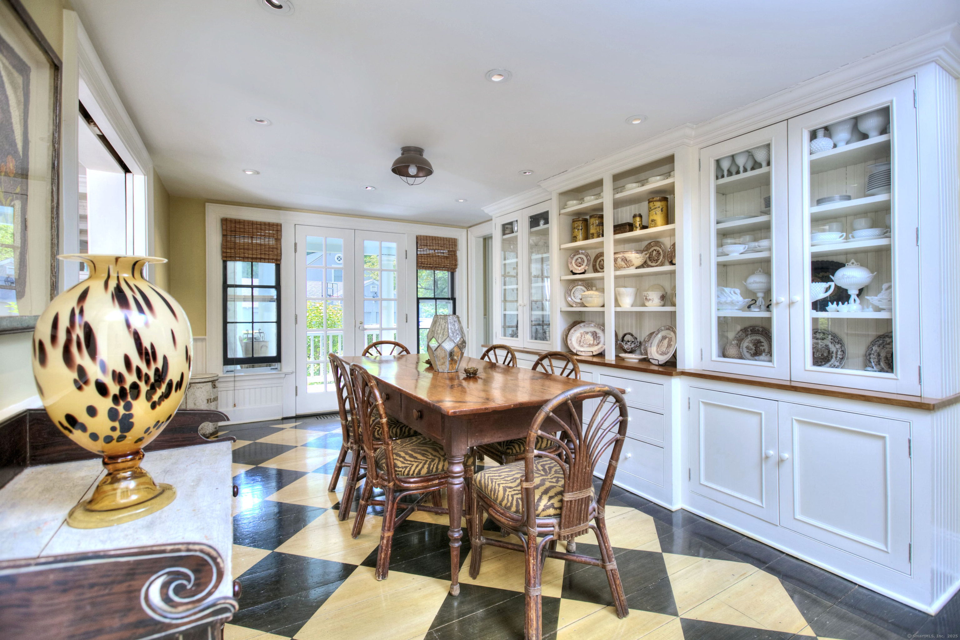 2683 Bronson Road Fairfield, CT 06824 - Photo 18 of 39 a dining room with furniture a window and a chandelier