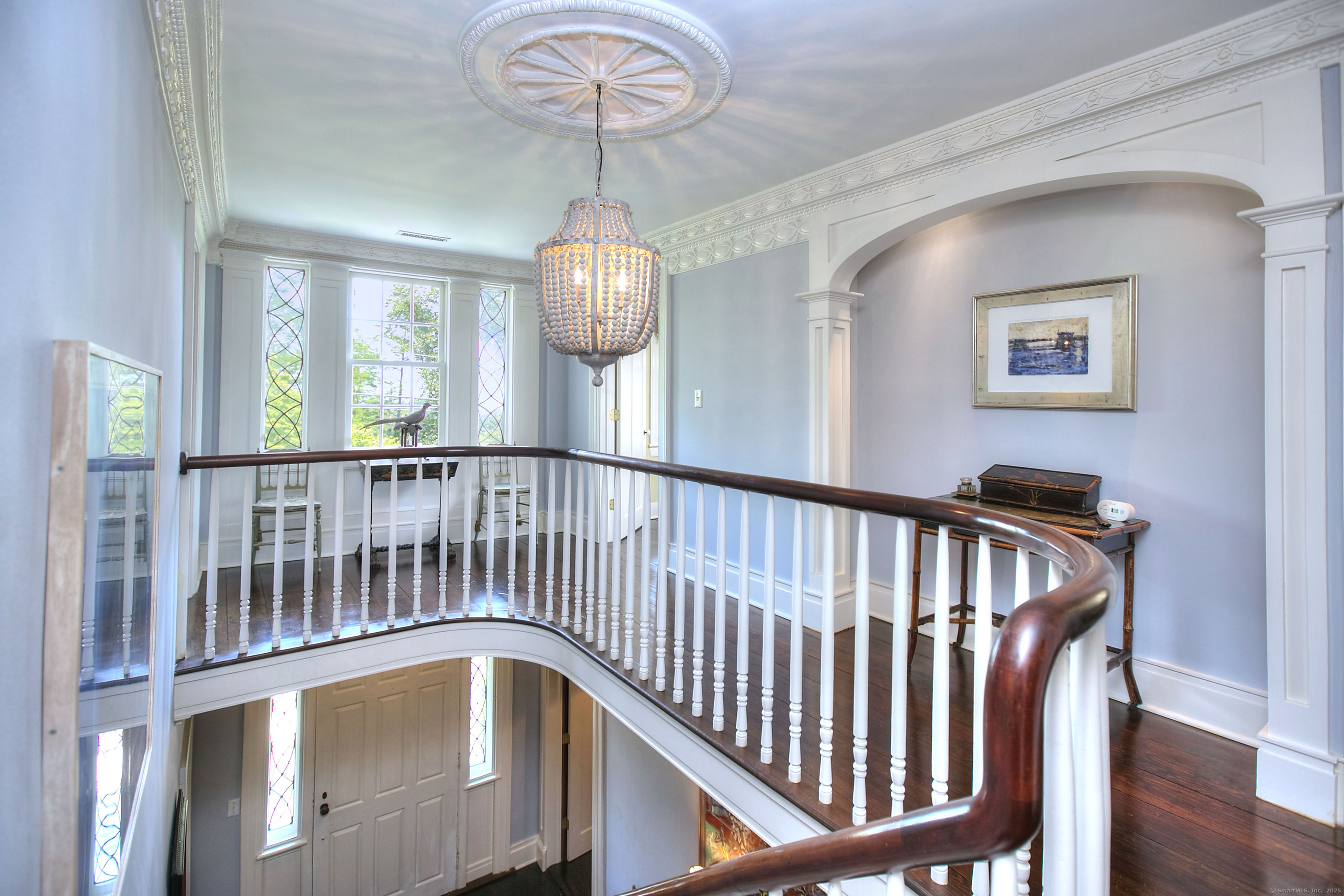 2683 Bronson Road Fairfield, CT 06824 - Photo 20 of 39 a view of a hallway with wooden floor and chandelier