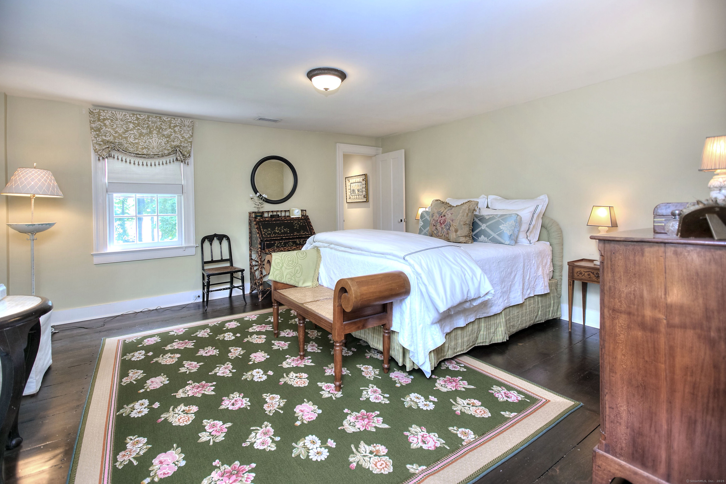 2683 Bronson Road Fairfield, CT 06824 - Photo 23 of 39 a bedroom with a bed and dresser with mirror