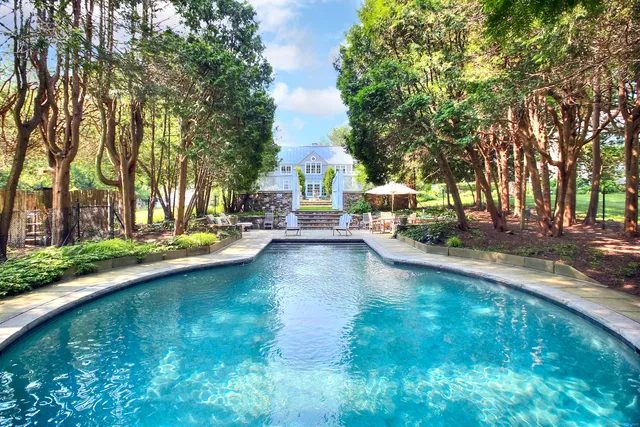 a view of yard with swimming pool and sitting area