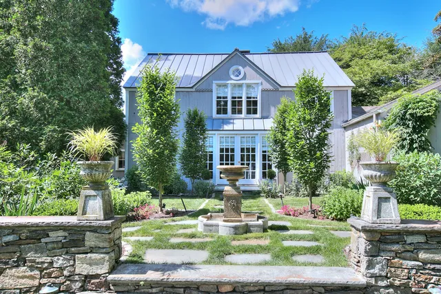 a front view of a house with garden