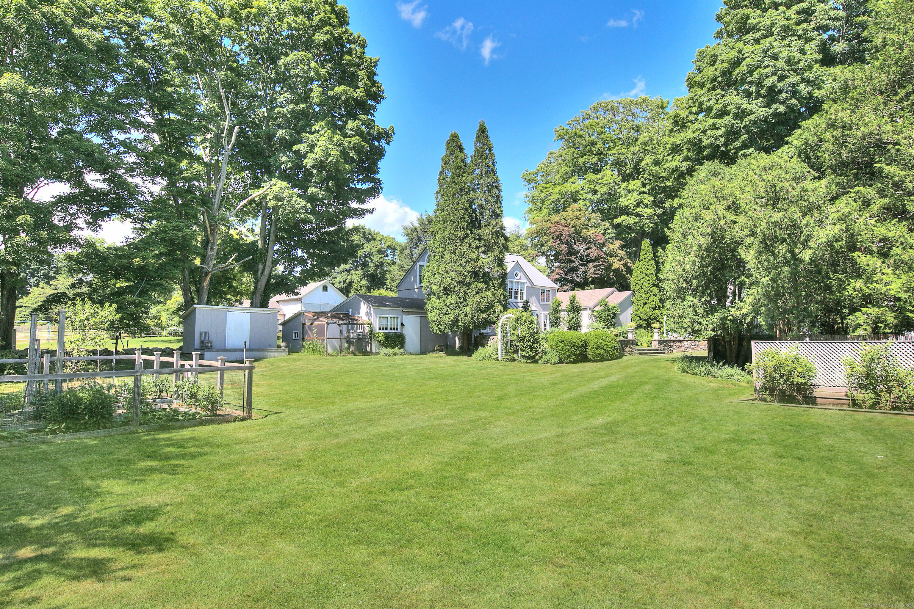 2683 Bronson Road Fairfield, CT 06824 - Photo 3 of 39 a view of a house with a yard and sitting area