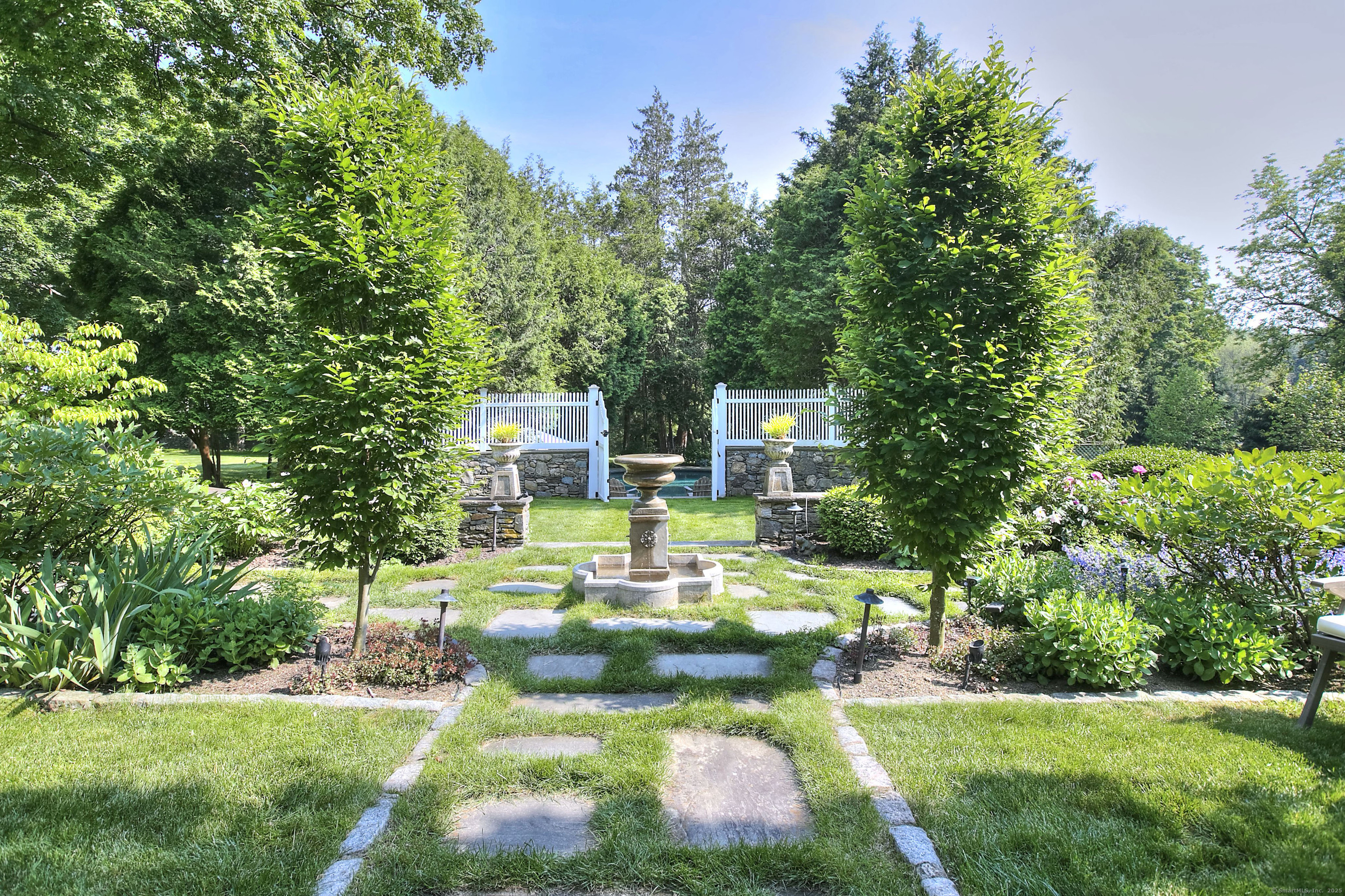 2683 Bronson Road Fairfield, CT 06824 - Photo 31 of 39 a view of a house with a big yard potted plants and large tree