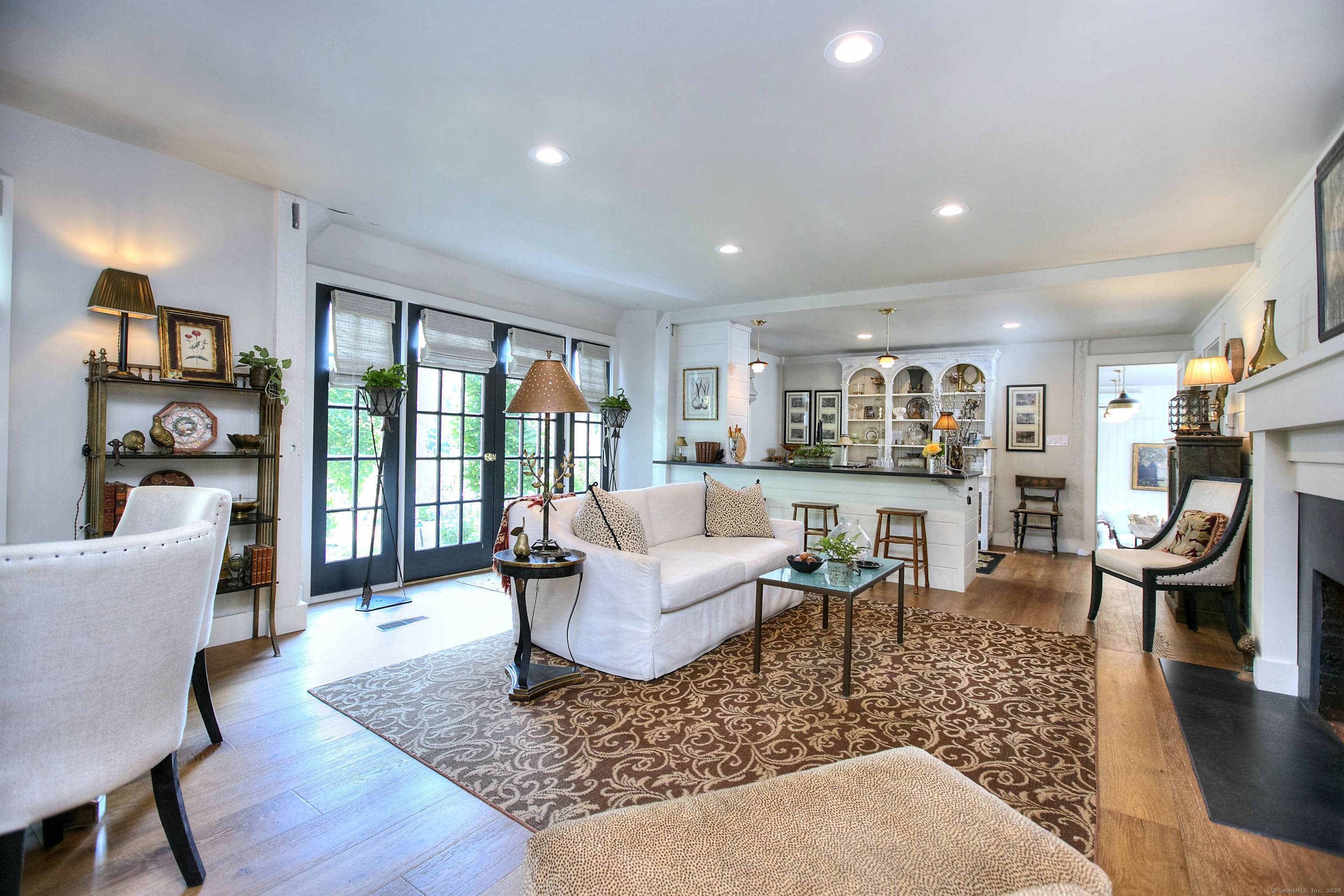 2683 Bronson Road Fairfield, CT 06824 - Photo 32 of 39 a living room with fireplace furniture and a wooden floor