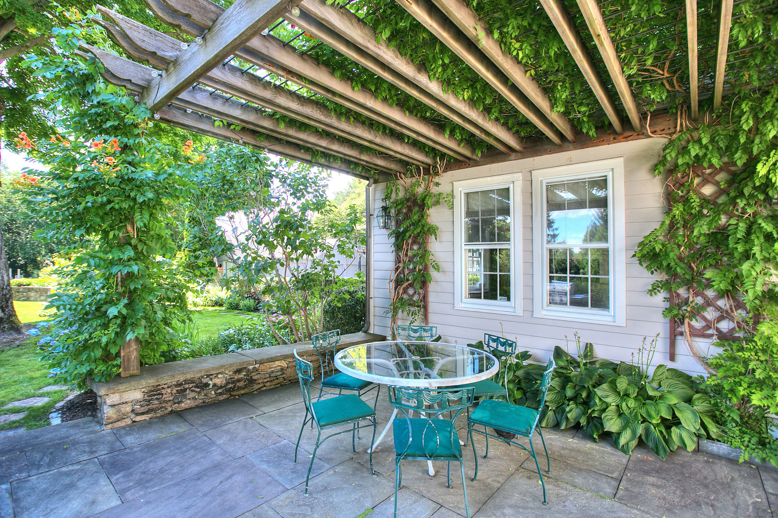 2683 Bronson Road Fairfield, CT 06824 - Photo 37 of 39 a view of patio with a table and chairs and potted plants