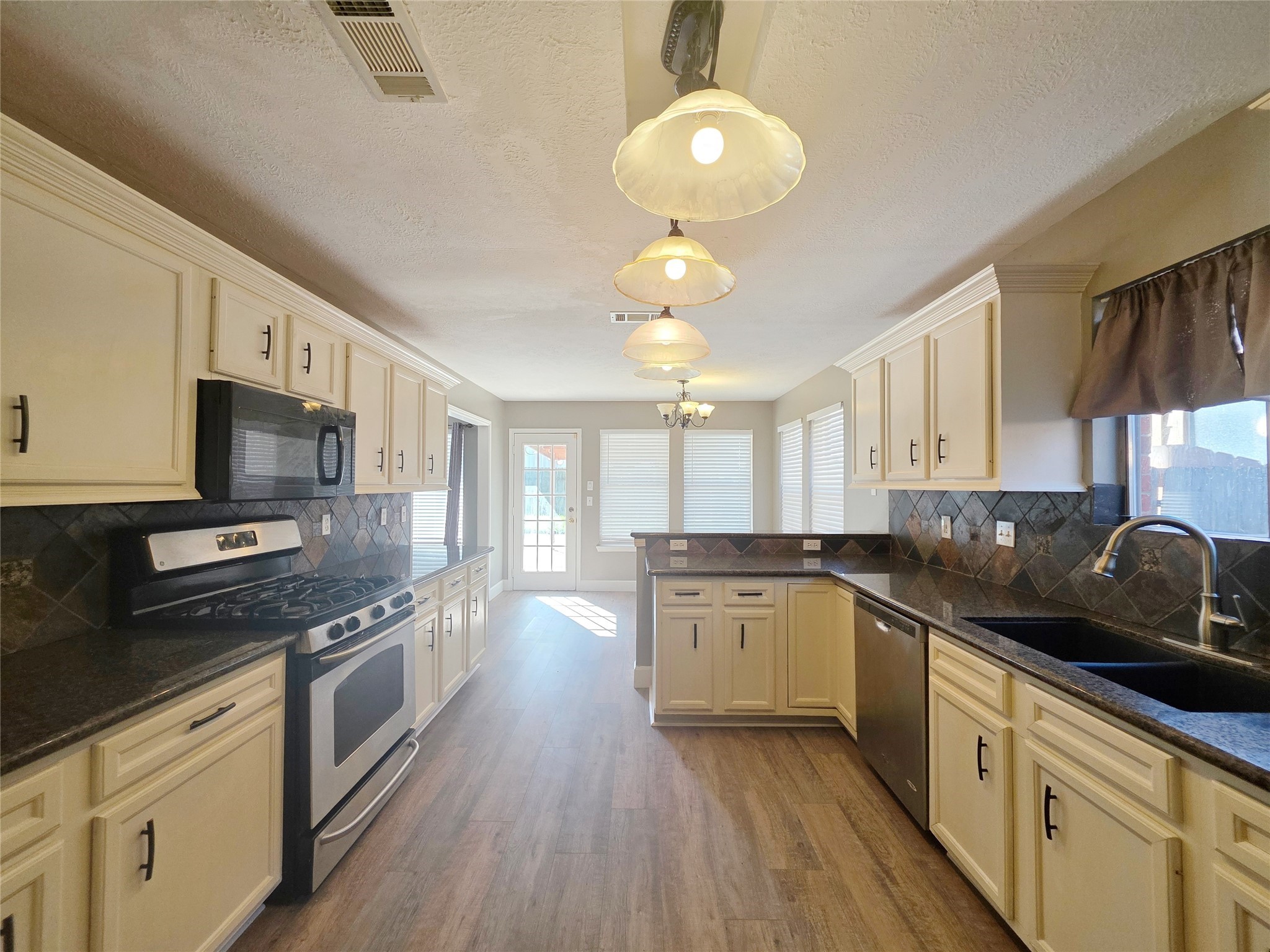 23527 Cansfield Way Katy, TX 77494 - Photo 13 of 30 a kitchen with stainless steel appliances granite countertop a sink stove and refrigerator