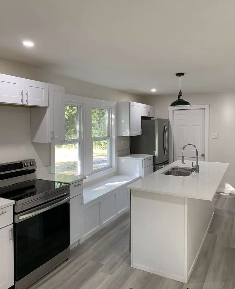a kitchen with a sink stove top oven and cabinets