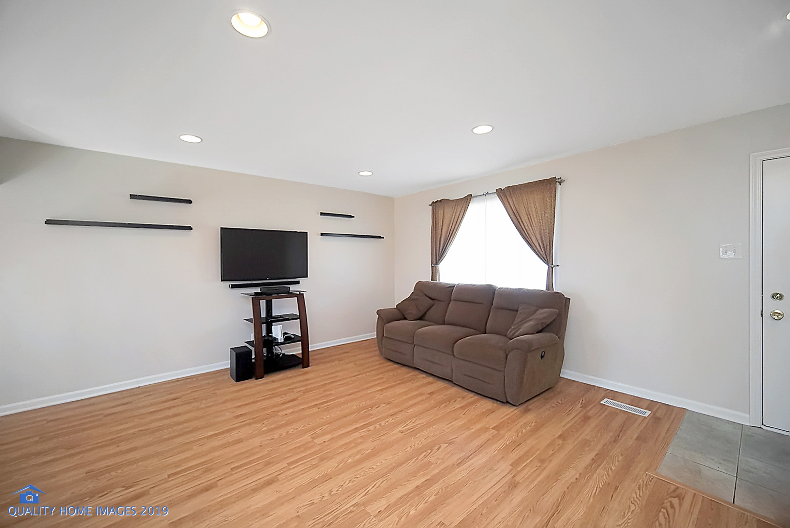 551 Spruce Road Bolingbrook, IL 60440 - Photo 3 of 22 a living room with furniture and a flat screen tv