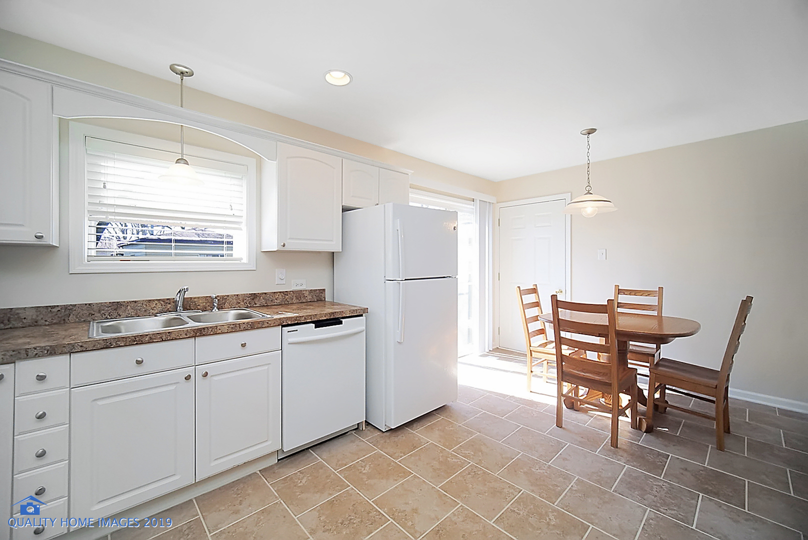 551 Spruce Road Bolingbrook, IL 60440 - Photo 5 of 22 a kitchen with stainless steel appliances granite countertop a sink and a refrigerator