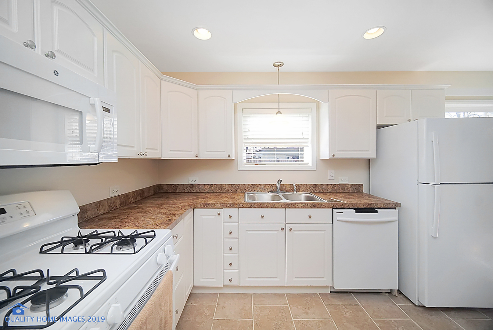 551 Spruce Road Bolingbrook, IL 60440 - Photo 6 of 22 a kitchen with granite countertop a sink stove and white cabinets