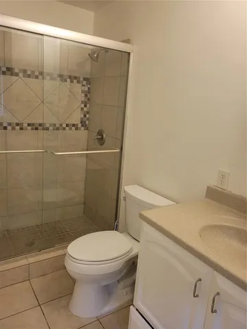 a white toilet sitting next to a bathroom sink
