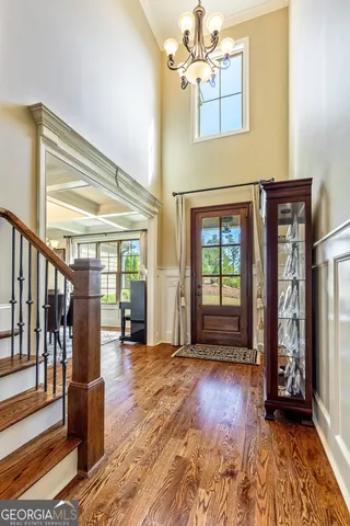 a view of a dining room with furniture large windows and wooden floor