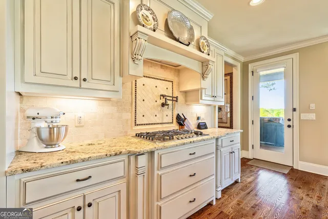 a living room with furniture a fireplace and a floor to ceiling window