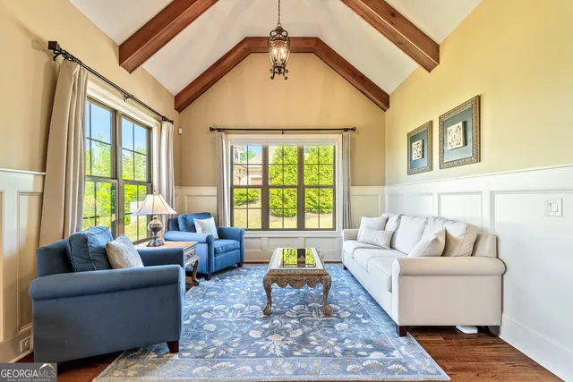 a living room with furniture and wooden floor