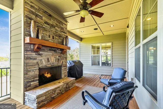 a living room with furniture and large windows