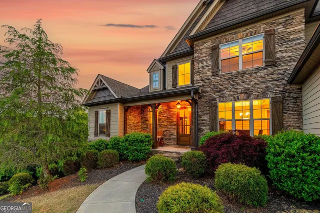 a front view of a building with a garden