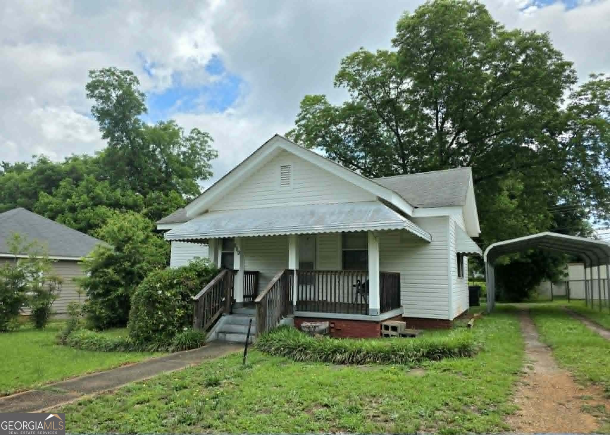119 O Street Southwest Thomaston, GA 30286 - Photo 1 of 9 a view of a house with a yard plants and large tree