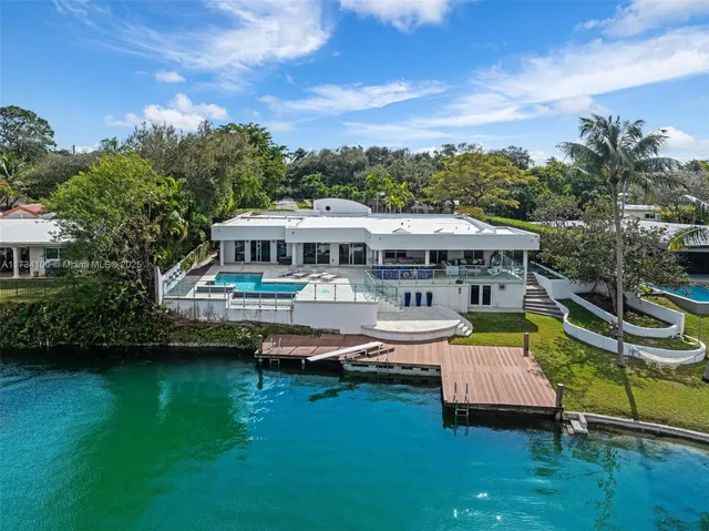 an aerial view of a house with swimming pool garden and patio