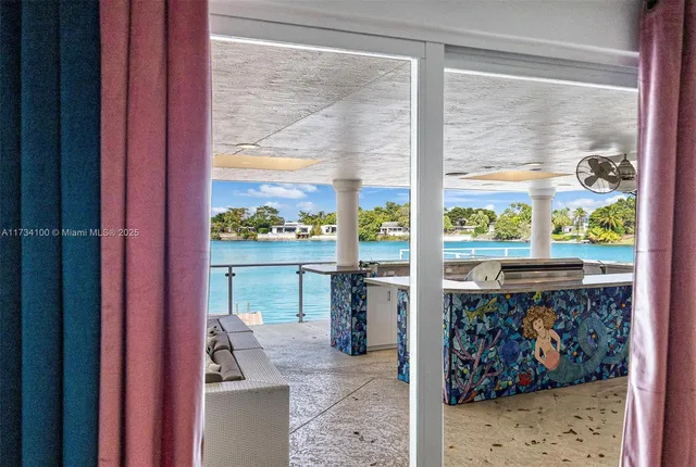 a kitchen with stainless steel appliances granite countertop a refrigerator a stove a sink a dining table and chairs