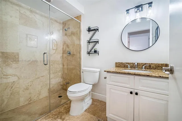 a large kitchen with stainless steel appliances granite countertop a stove and cabinets