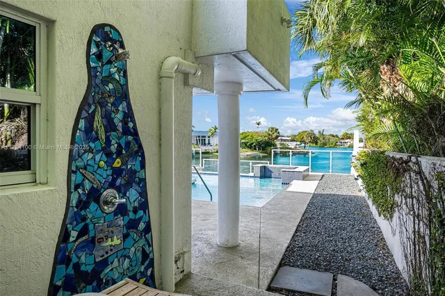 a front view of a house with a garden and plants