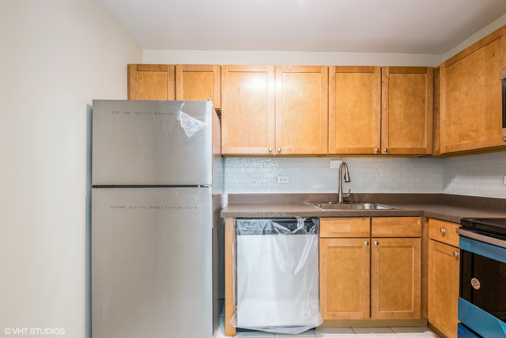 655 West Irving Park Road, Unit 1505 Chicago, IL 60613 - Photo 13 of 23 a white refrigerator freezer sitting inside of a kitchen