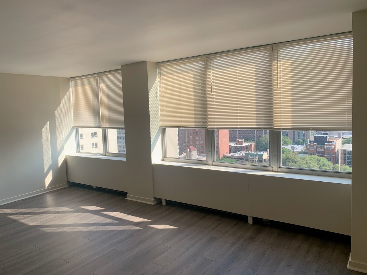 655 West Irving Park Road, Unit 1505 Chicago, IL 60613 - Photo 16 of 23 a view of an empty room with wooden floor and a window
